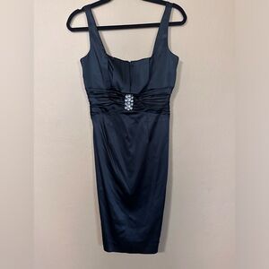 Black satin style Calvin Klein dress. Big rhinestone cluster in the middle.
